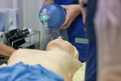 Cropped image of person learning cpr in hospital