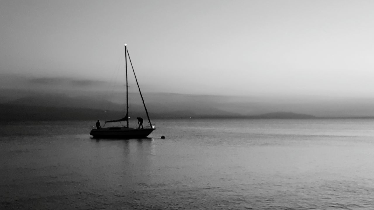 water, nautical vessel, sea, nature, sky, outdoors, transportation, beauty in nature, waterfront, silhouette, tranquility, tranquil scene, horizon over water, no people, sunset, fog, scenics, day, sailboat