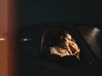 Woman looking away while sitting in car