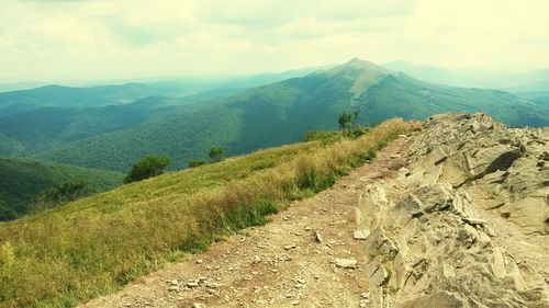 Scenic view of mountains against cloudy sky