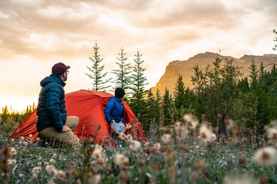 Couple enjoying sunrise from camping spot along david thompson highway