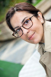 Portrait of smiling woman wearing eyeglasses at sidewalk cafe