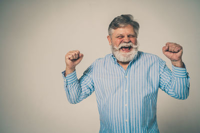 Portrait of man standing against white background