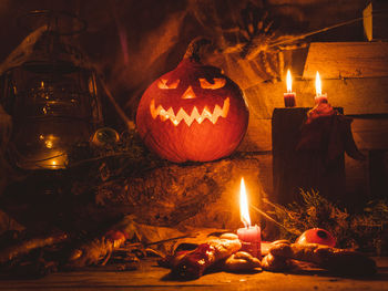 Lit candles on display at night