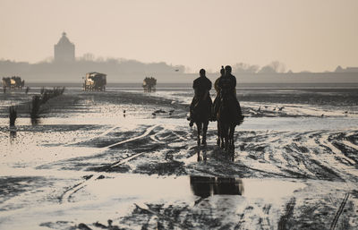 People on snow covered land