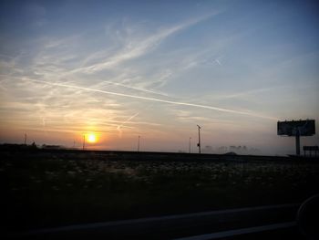 Scenic view of silhouette field against sky during sunset