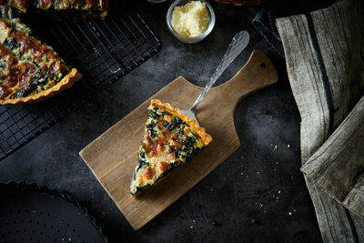 High angle view of pizza on cutting board