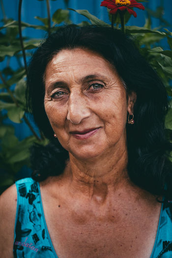 Portrait of smiling senior woman with black hair