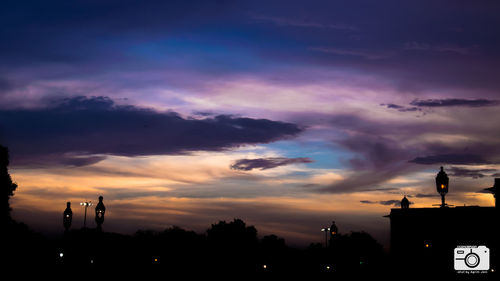 Low angle view of silhouette buildings against sky during sunset