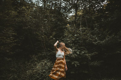 Woman standing in forest