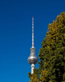 Low angle view of fernsehturm against clear blue sky