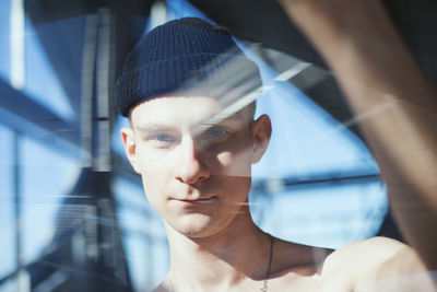 Portrait of man looking through window