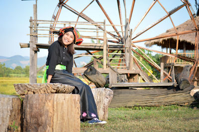 Portrait of smiling man sitting on wood