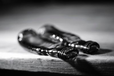 Close-up of melted glass bottles on wooden table