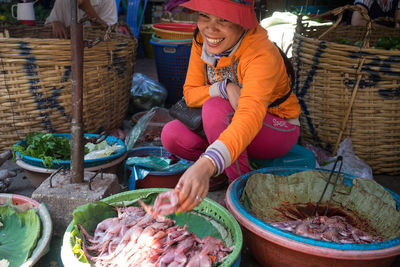 High-angle view of a woman selling frogs at the wet market in phnom penh, cambodia
