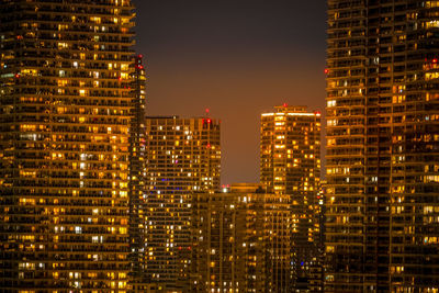 Illuminated buildings in city at night