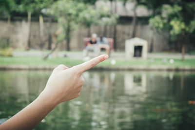 Hand holding water against blurred background