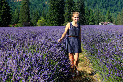 Portrait of young woman standing on field