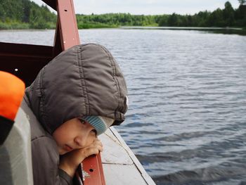 Rear view of man on boat in lake