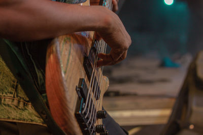 Cropped image of man playing guitar