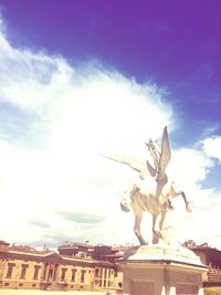 Low angle view of statue against cloudy sky