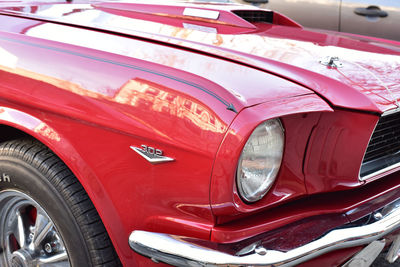 Reflection of red car in side-view mirror