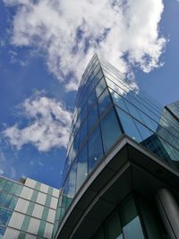 Low angle view of modern building against blue sky