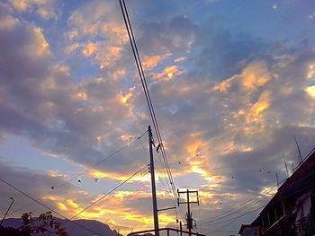 Low angle view of cables against sky during sunset