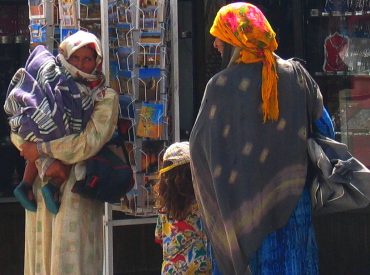 REAR VIEW OF PEOPLE AT MARKET