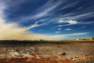 Scenic view of landscape against cloudy sky