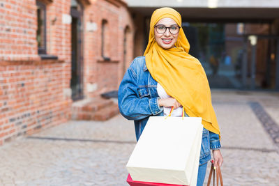 Portrait of a smiling young woman in city