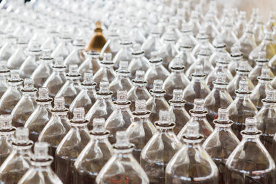 Full frame shot of glass bottles arranged in factory