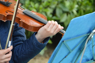 Close-up of person playing violin