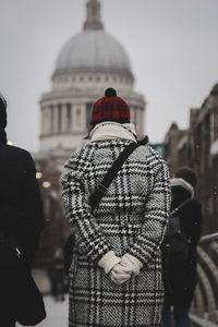 Rear view of people walking on street in winter