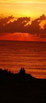 Scenic view of sea against orange sky