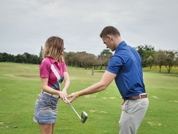 Couple playing golf 