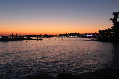 Scenic view of sea against clear sky at sunset