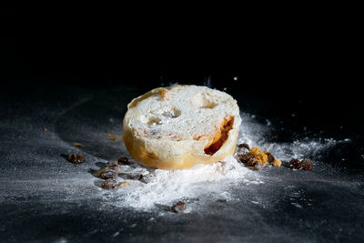 Close-up of cake against black background