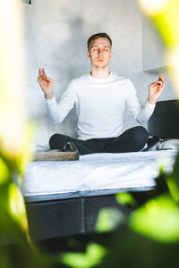 Portrait of young man sitting outdoors