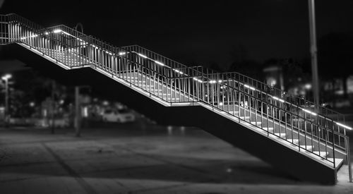 Illuminated bridge against sky at night