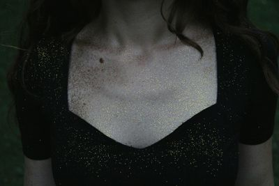 Close-up of woman with glitter on body