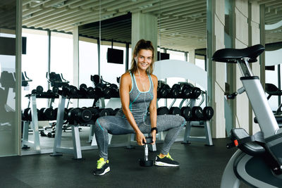 Portrait of woman exercising in gym