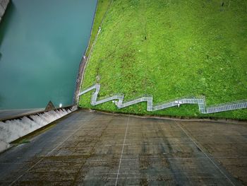 Footpath by wall against sky