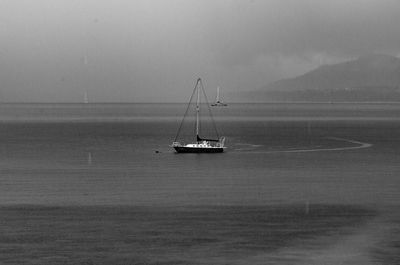 Ship sailing on sea against sky