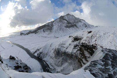 Scenic view of snowcapped mountains against sky