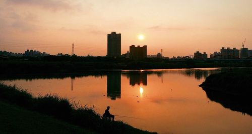 Scenic view of calm river at sunset