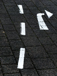 High angle view of arrow symbol on road