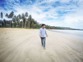 Full length of man standing on beach