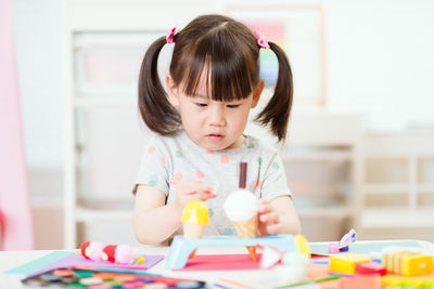 Close-up of girl making craft for home schooling