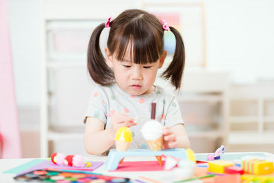 Close-up of girl drawing on table